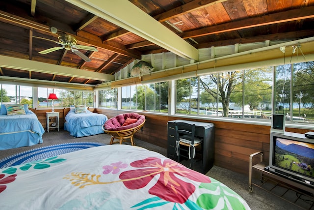 carpeted bedroom featuring wooden ceiling and wooden walls