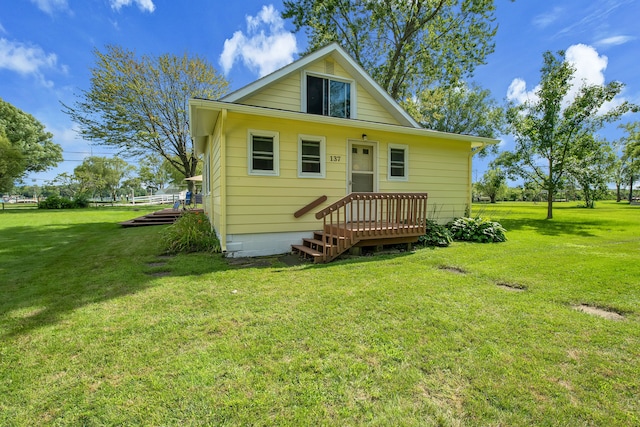 rear view of house featuring a yard