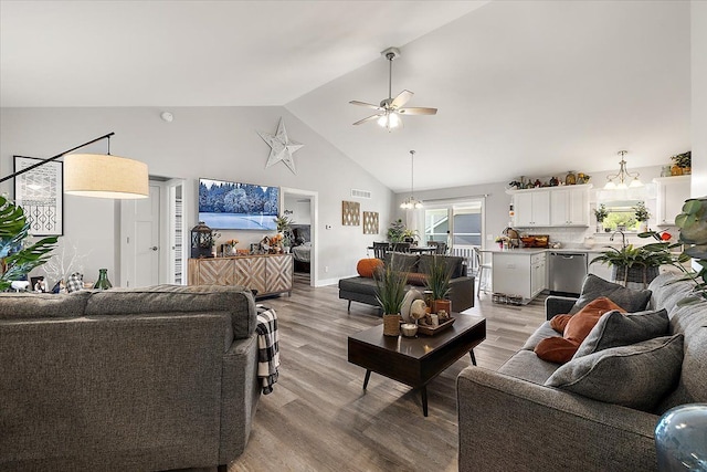 3582 Pratt Dr, Lapeer, MI 48446 - living area featuring a chandelier, ceiling fan, high vaulted ceiling, and light wood finished floors
