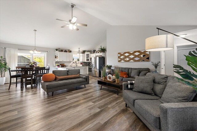 3582 Pratt Dr, Lapeer, MI 48446 - living room featuring a ceiling fan, high vaulted ceiling, wood finished floors, and a chandelier