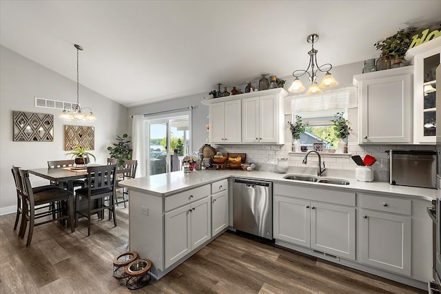 3582 Pratt Dr, Lapeer, MI 48446 - kitchen with dishwasher, a sink, a chandelier, a peninsula, and vaulted ceiling