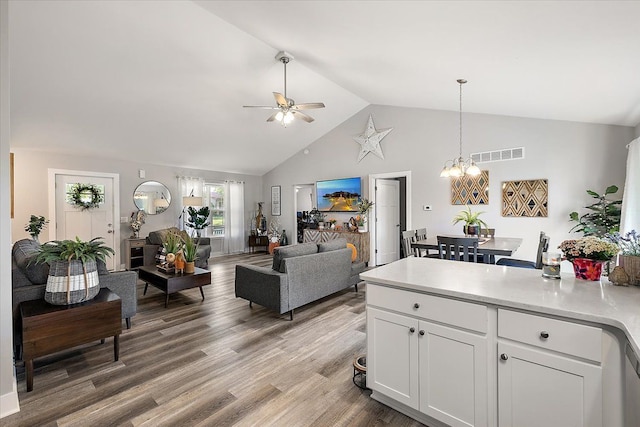 3582 Pratt Dr, Lapeer, MI 48446 - living room with ceiling fan, a chandelier, light wood-style floors, and high vaulted ceiling