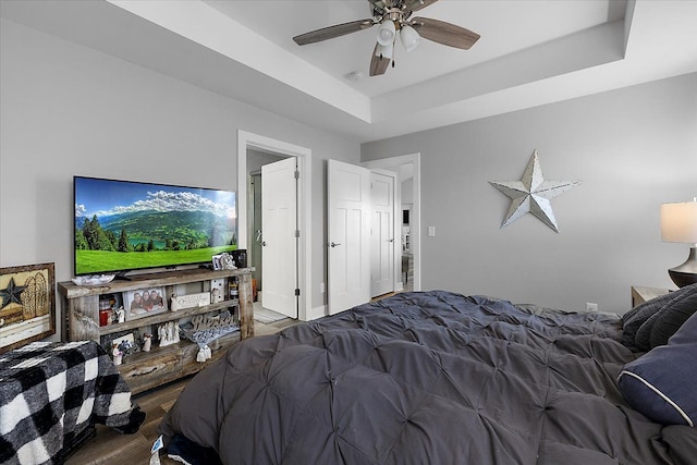 3582 Pratt Dr, Lapeer, MI 48446 - bedroom featuring wood finished floors, a tray ceiling, and a ceiling fan