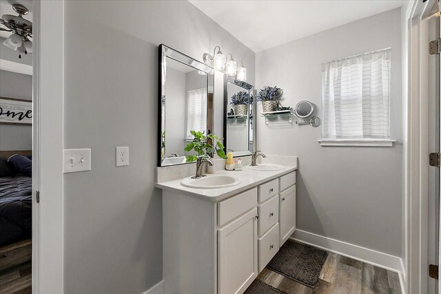 3582 Pratt Dr, Lapeer, MI 48446 - ensuite bathroom featuring wood finished floors, baseboards, double vanity, and a ceiling fan