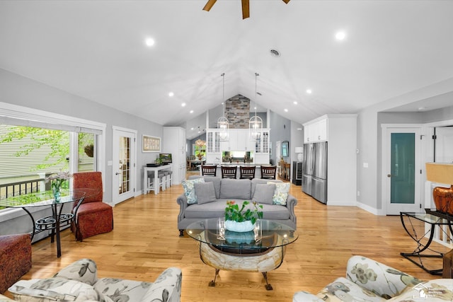 2307 Tecumseh Dr, Brooklyn, MI 49230 - living area featuring a ceiling fan, light wood finished floors, high vaulted ceiling, a chandelier, and baseboards