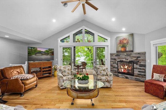 2307 Tecumseh Dr, Brooklyn, MI 49230 - living room featuring lofted ceiling, ceiling fan, a fireplace, wood finished floors, and recessed lighting