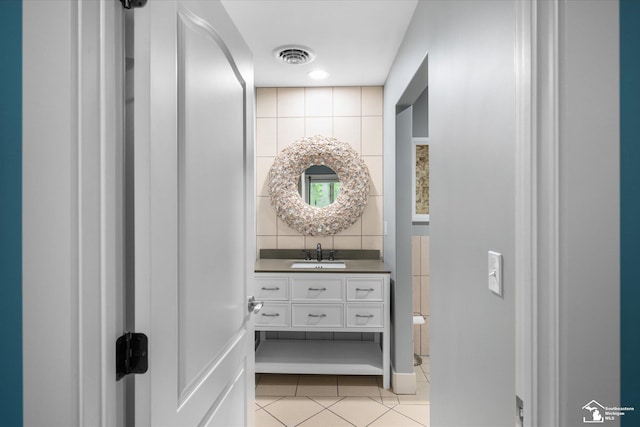 2307 Tecumseh Dr, Brooklyn, MI 49230 - bathroom featuring tile patterned flooring, tile walls, and vanity