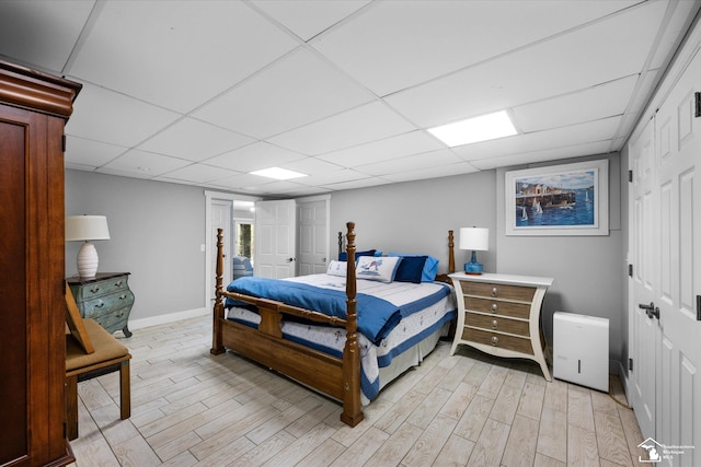2307 Tecumseh Dr, Brooklyn, MI 49230 - bedroom with light wood finished floors, baseboards, and a paneled ceiling