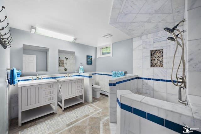 2307 Tecumseh Dr, Brooklyn, MI 49230 - full bath with a tile shower, a baseboard radiator, two vanities, and toilet