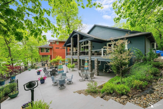 2307 Tecumseh Dr, Brooklyn, MI 49230 - rear view of property with a patio area and outdoor dining area