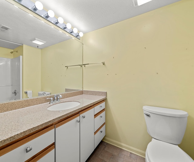1379 Millbrook Trl, Ann Arbor, MI 48108 - full bath featuring toilet, baseboards, vanity, a shower, and stone finish floors