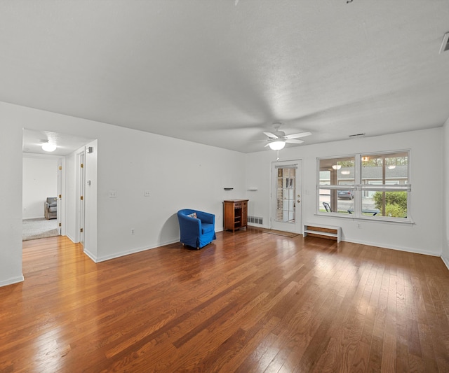 1379 Millbrook Trl, Ann Arbor, MI 48108 - unfurnished living room with wood-type flooring, ceiling fan, and baseboards