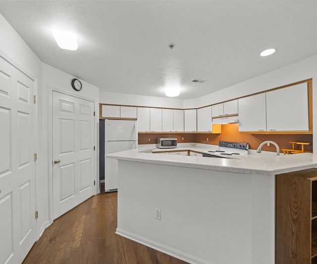 1379 Millbrook Trl, Ann Arbor, MI 48108 - kitchen with freestanding refrigerator, range with electric cooktop, stainless steel microwave, under cabinet range hood, and white cabinetry