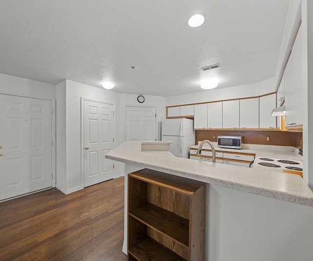 1379 Millbrook Trl, Ann Arbor, MI 48108 - kitchen featuring stainless steel microwave, freestanding refrigerator, open shelves, a peninsula, and dark wood finished floors
