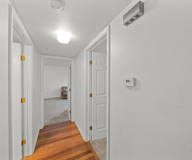 1379 Millbrook Trl, Ann Arbor, MI 48108 - corridor with a textured ceiling and wood finished floors
