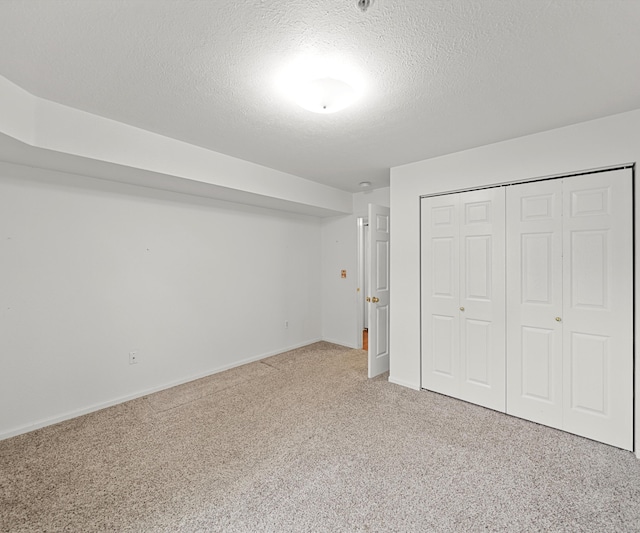 1379 Millbrook Trl, Ann Arbor, MI 48108 - unfurnished bedroom featuring carpet, a closet, a textured ceiling, and baseboards