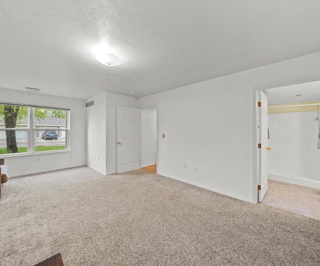 1379 Millbrook Trl, Ann Arbor, MI 48108 - spare room featuring light carpet, baseboards, and a textured ceiling