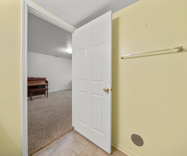 1379 Millbrook Trl, Ann Arbor, MI 48108 - hallway featuring light colored carpet, a textured ceiling, and baseboards