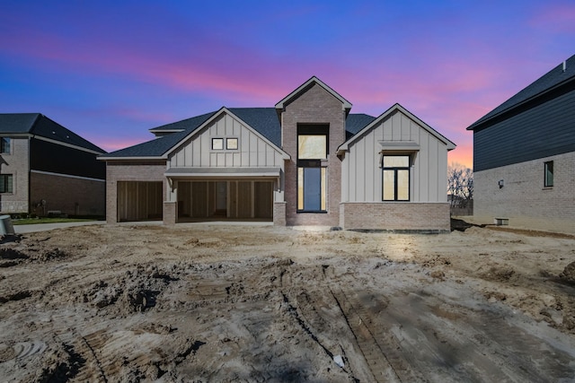 45070 Twin River Dr, Macomb, MI 48044 - modern farmhouse style home with board and batten siding, brick siding, and an attached garage