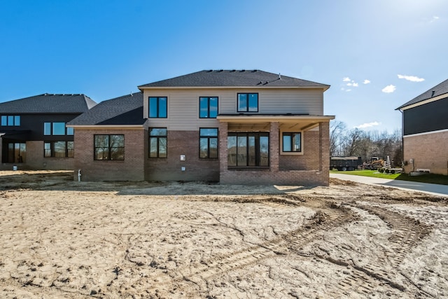 45070 Twin River Dr, Macomb, MI 48044 - rear view of property featuring brick siding and roof with shingles
