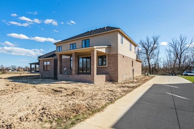 45070 Twin River Dr, Macomb, MI 48044 - back of house featuring brick siding