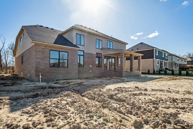 45070 Twin River Dr, Macomb, MI 48044 - back of property featuring brick siding and roof with shingles