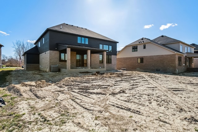 45070 Twin River Dr, Macomb, MI 48044 - rear view of house featuring brick siding and central AC