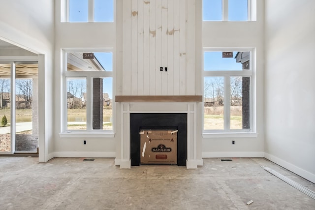45070 Twin River Dr, Macomb, MI 48044 - unfurnished living room with healthy amount of natural light, a fireplace, and baseboards