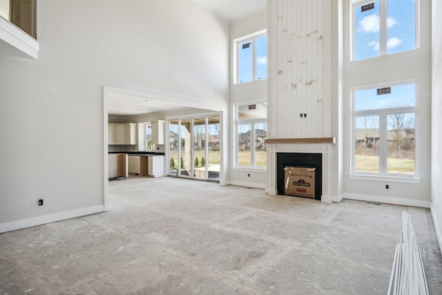 45070 Twin River Dr, Macomb, MI 48044 - unfurnished living room with a high ceiling, baseboards, and a large fireplace