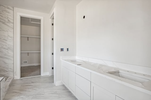 45070 Twin River Dr, Macomb, MI 48044 - bathroom featuring marble look tiles and a shower
