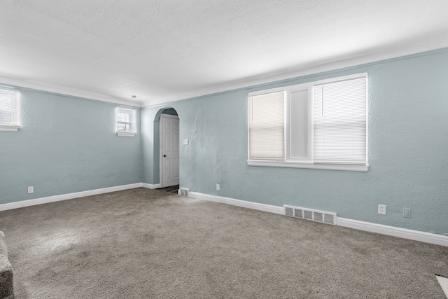 15748 Freeland St, Detroit, MI 48227 - carpeted spare room featuring arched walkways, baseboards, and a textured wall
