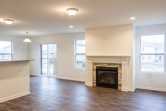 58216 Kincaid St, New Haven, MI 48048 - unfurnished living room featuring dark wood-style floors, baseboards, a fireplace, and recessed lighting