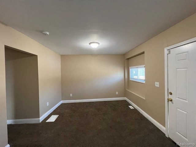 5671 Otis St, Detroit, MI 48210 - empty room featuring dark carpet, a smoke detector, and baseboards