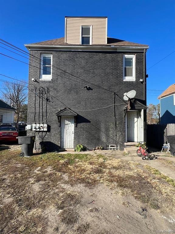 5671 Otis St, Detroit, MI 48210 - rear view of house with brick siding