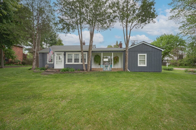406 Common St, Walled Lake, MI 48390 - view of front of home with a front lawn and a chimney
