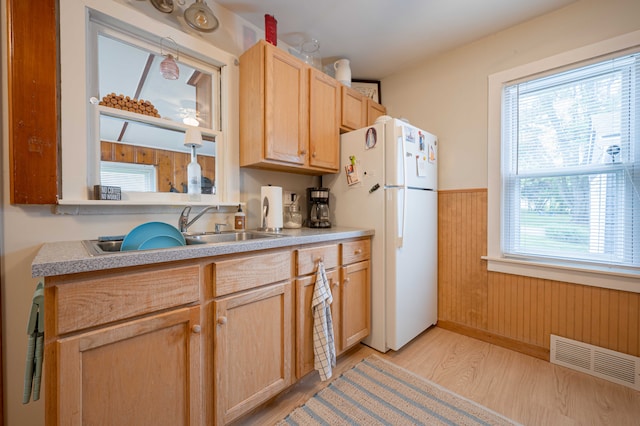 406 Common St, Walled Lake, MI 48390 - kitchen featuring freestanding refrigerator, a sink, light brown cabinets, wainscoting, and light wood-type flooring