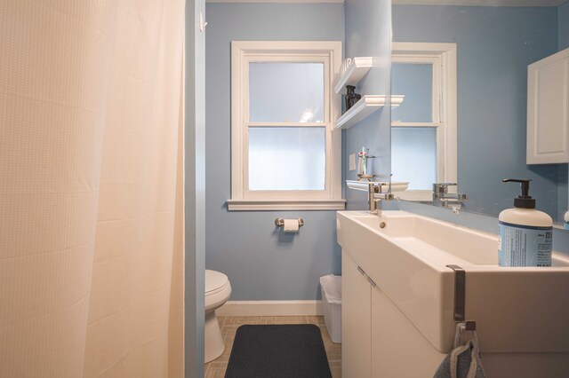 406 Common St, Walled Lake, MI 48390 - bathroom featuring toilet, vanity, baseboards, and tile patterned floors