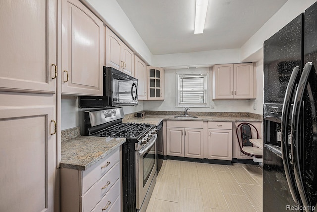 259 Navajo Ave, Pontiac, MI 48341 - kitchen featuring black appliances, a sink, and glass insert cabinets