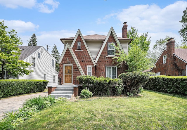 259 Navajo Ave, Pontiac, MI 48341 - tudor-style house featuring a front yard and brick siding
