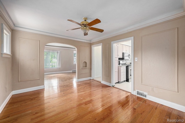 259 Navajo Ave, Pontiac, MI 48341 - unfurnished room with arched walkways, ceiling fan, light wood-type flooring, ornamental molding, and baseboards