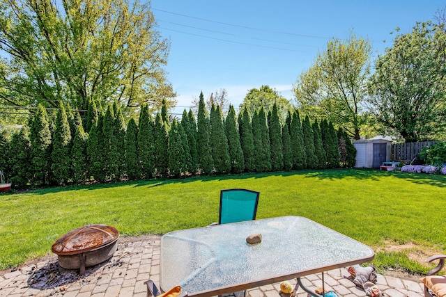 935 S Brys Dr, Grosse Pointe Woods, MI 48236 - view of yard featuring a patio, a storage shed, a fire pit, an outbuilding, and outdoor dining space