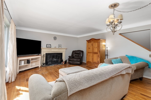 935 S Brys Dr, Grosse Pointe Woods, MI 48236 - living room featuring a chandelier, a fireplace, and wood finished floors