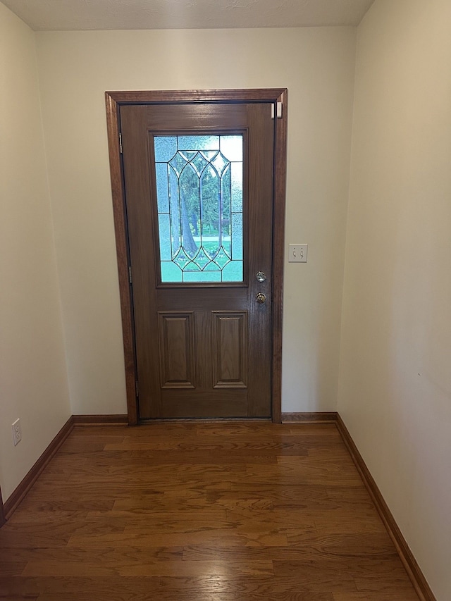 entrance foyer with baseboards and wood finished floors