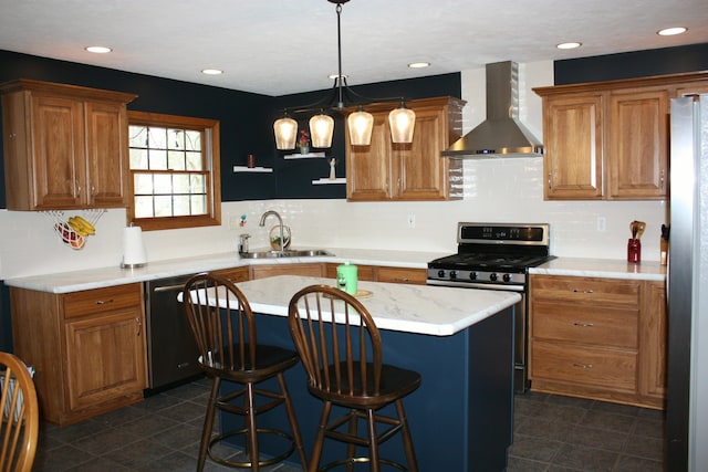 kitchen featuring wall chimney exhaust hood, a sink, appliances with stainless steel finishes, dark tile patterned floors, and recessed lighting