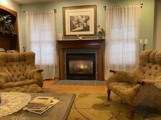 sitting room featuring a fireplace with flush hearth