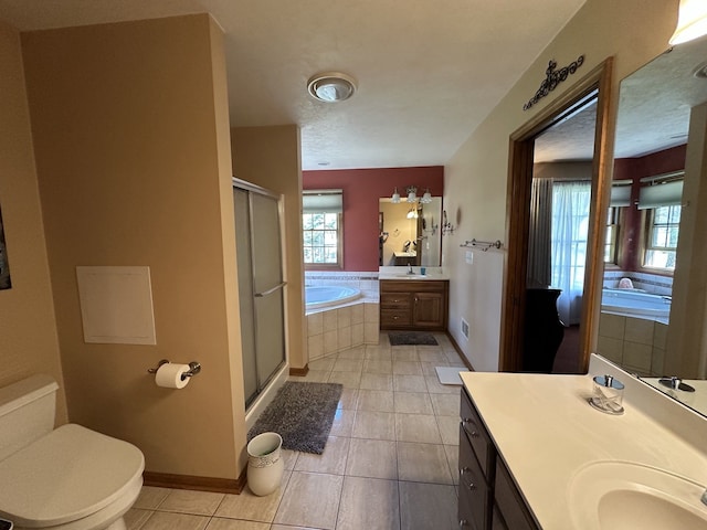 full bath featuring a stall shower, a bath, vanity, tile patterned flooring, and baseboards