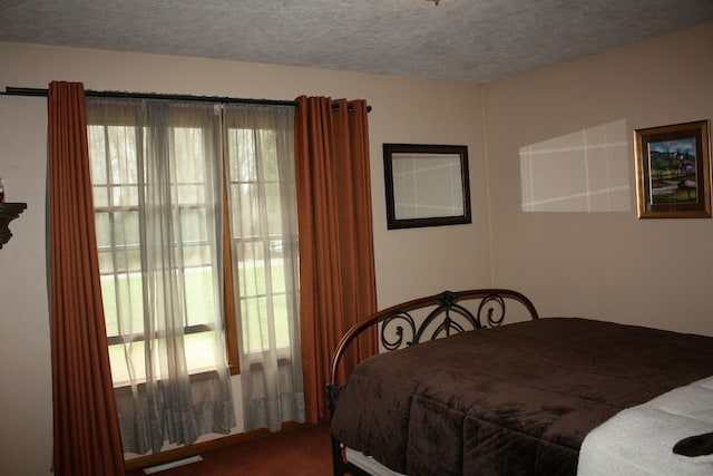 bedroom featuring carpet flooring and a textured ceiling