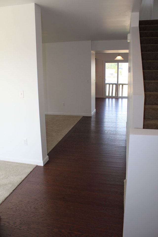 58192 Kincaid St, New Haven, MI 48048 - hallway with baseboards, stairs, and dark wood-style floors
