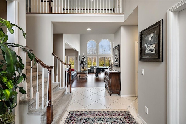 58 Ingram Dr, Troy, MI 48098 - entrance foyer featuring a high ceiling, light tile patterned floors, stairs, and baseboards