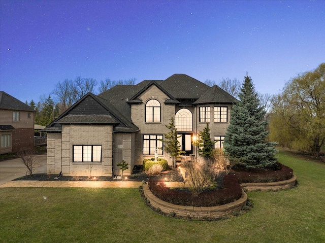 58 Ingram Dr, Troy, MI 48098 - french country inspired facade with a front lawn and brick siding